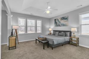 a bedroom with a large bed and two windows at Spacious Family Retreat in Atlanta - Sleeps 10 in Enon