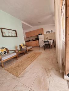 a living room with a couch and a table at Roni's Place in Nea Kallikrateia +28 photos