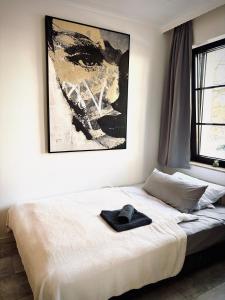 オスナブリュックにあるCity Apartment Osnabrück -- inklusive Parkplatz & WiFi, vollausgestattete Küche mit Geschirrspüler -- Perfekt für Urlaub & Businessの帽子が置かれたベッドのある寝室