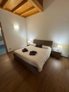a bedroom with a large bed with two bags on it at Ca' Piramidi Casa Vacanze in Postalesio