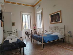 Posteľ alebo postele v izbe v ubytovaní Palazzo Castellano