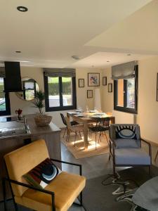 a kitchen and living room with a table and chairs at Loulipo in Gerbépal