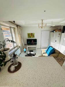 a living room with a table and a couch at Bolod Guesthouse and Tours in Ulaanbaatar +2 photos