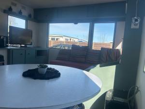a living room with a table and a couch at Dutch calmness in Hoek