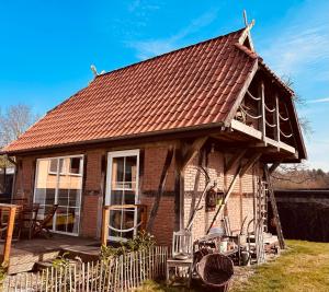 a small brick house with a brown roof at Ferienhaus Waldweg in Wienhausen