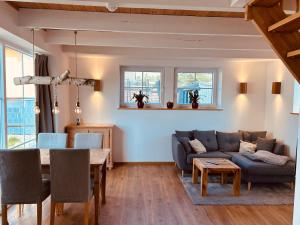 a living room with a couch and a table at Ferienhaus Waldweg in Wienhausen