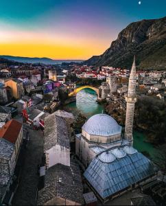 an aerial view of a city with a bridge and a mosque at Apartments Isabella in Mostar