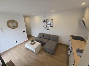 a living room with a couch and a table at Chiclanafactory in Chiclana de la Frontera