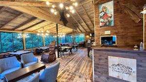 a restaurant with wooden walls and tables and chairs at Kaledome Eco Mountain Resort in Çamlıhemşin
