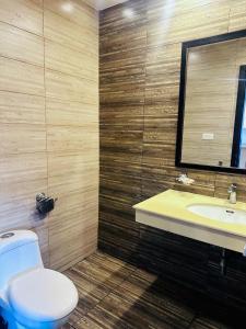 a bathroom with a toilet and a sink and a mirror at Executive appartment in bahria hieghts 1 in Rawalpindi +6 photos