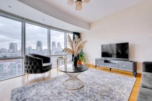 a living room with a tv and a couch and a table at Residence with city view in Basaksehir