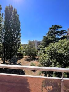 a fence next to a road with trees at Flower spa - Jacuzzi intérieur - T2 in Toulouse