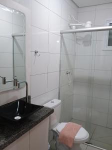 a bathroom with a shower and a toilet and a sink at Apto6 com WI-FI e garagem e 100 a av Brasil in Passo Fundo