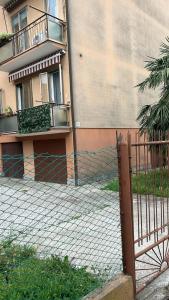 a fence in front of a building at Cozy Best Apartment In City With Free Parking in Venice