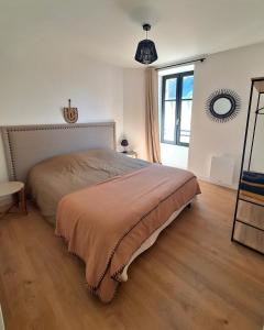 a bedroom with a bed and a large window at L'éclipse - T4 sur le port du Pouliguen in Le Pouliguen