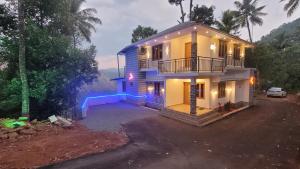 a house with lights on the side of it at NewCastle Holidays Resorts-Entire Property 5 Bedrooms-Great Mountain & River View-Between Munnar & Idukki with Kitchen in Idukki