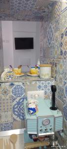 a kitchen with blue and white tiles on the wall at DonnaSofia in Cetara