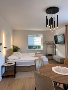 a bedroom with a large bed and a table at Agroturystyka Pod Jałowcem in Stryszawa