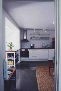 a kitchen with white cabinets and a table at Spacious scenic in Stockholm +13 photos