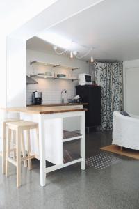 a kitchen with a white island in a room at Spacious scenic in Stockholm