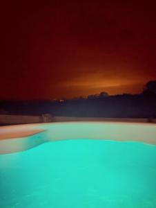 a swimming pool at night with the sky in the background at Caplor Glamping & Lodges in Hereford