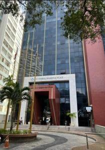a large building with a sign in front of it at Bahia Hotel Sol Vitoria Marina Flats in Salvador