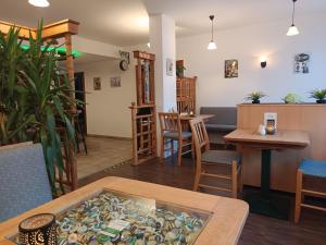 a room with a table and chairs and a bar at Gasthof am Markt in Edewecht