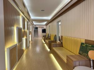 a corridor of a hospital with benches and tables at Winston Hotel in Bangkok