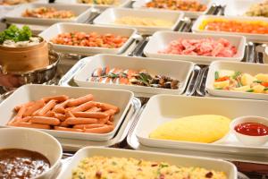 a buffet with many trays of different types of food at Hotel Royal Morioka in Morioka