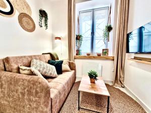 a living room with a couch and a table at Central Park Lublin in Lublin +36 photos