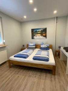 a bedroom with two beds and a painting on the wall at Haus Gerda in Neustadt an der Weinstraße