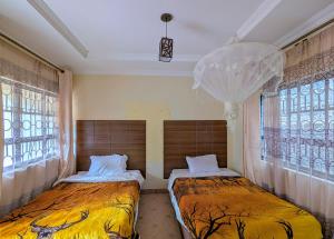 Ένα ή περισσότερα κρεβάτια σε δωμάτιο στο Hillsgate Homes Lodge in Namanga