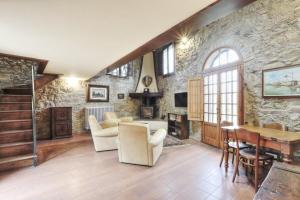 a large living room with a stone wall at Spacious Villa with Private Pool & Garden near Chianti in Impruneta