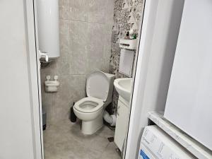 a small bathroom with a toilet and a sink at Студио за гости на град Бургас in Burgas City