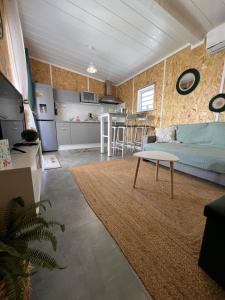 a living room with a couch and a table at Lebon Coin Tranquille in Le Tampon +18 photos