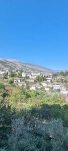 a view of a city with buildings in the distance at Magnolia's Private Room in Gjirokastër