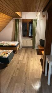 a large room with two beds and a window at CASA Del SUR in Braunschweig