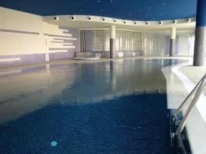 a swimming pool in a building with a large pool at Mojacar Playa Atalaya Résidence in Mojácar +7 photos