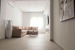a living room with a couch and a table at ZISE Luxury Apartments in Corfu