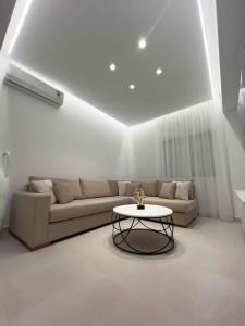 a living room with a couch and a table at ZISE Luxury Apartments in Corfu