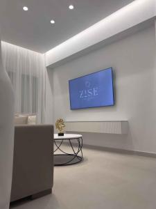 a living room with a tv on a wall at ZISE Luxury Apartments in Corfu Town +67 photos
