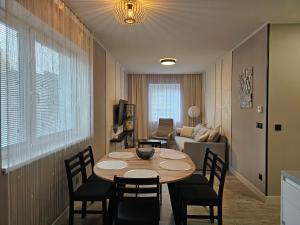 a living room with a table and chairs and a couch at Apartmán New4 in Olomouc