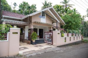 a house with a gate in front of it at Swasth The Riviera Lovedale in Nilambūr
