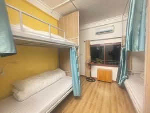 a bedroom with two bunk beds and a window at Tamcoc Backpackers Hostel Homestay in Ninh Binh +22 photos