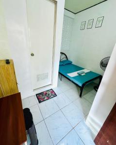 a small room with a bed and a door at Wakims in Coron