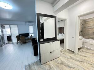 a bathroom with a dresser with a mirror on it at Bucharest Premium Luxury Studios & Apartments by Glam Story in Bucharest +64 photos
