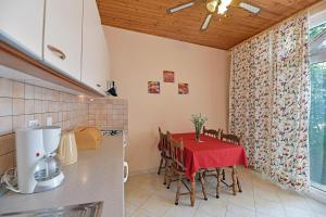 a kitchen with a table with a red table cloth at Apartments Mićić in Hvar +21 photos
