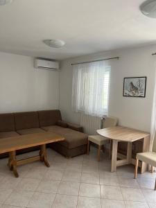 a living room with a couch and a table at Apartments Vido in Vodice