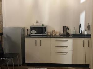 a kitchen with a microwave and a refrigerator at Genuine Resort Kandy in Kandy