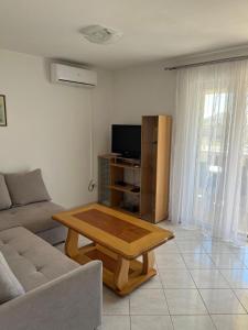 a living room with a couch and a coffee table at Apartments Vido in Vodice